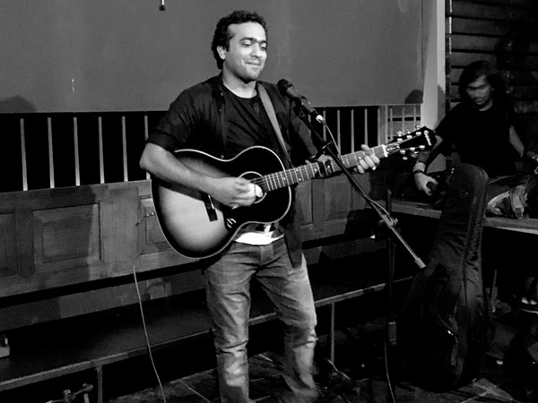 Sri Charan Pakala performing with an acoustic guitar